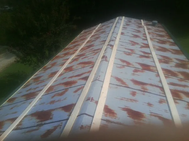 Rusted metal roof panels with new wood purlins before replacement — Storm Damage Roof Repair in Effingham by Roofing Brothers